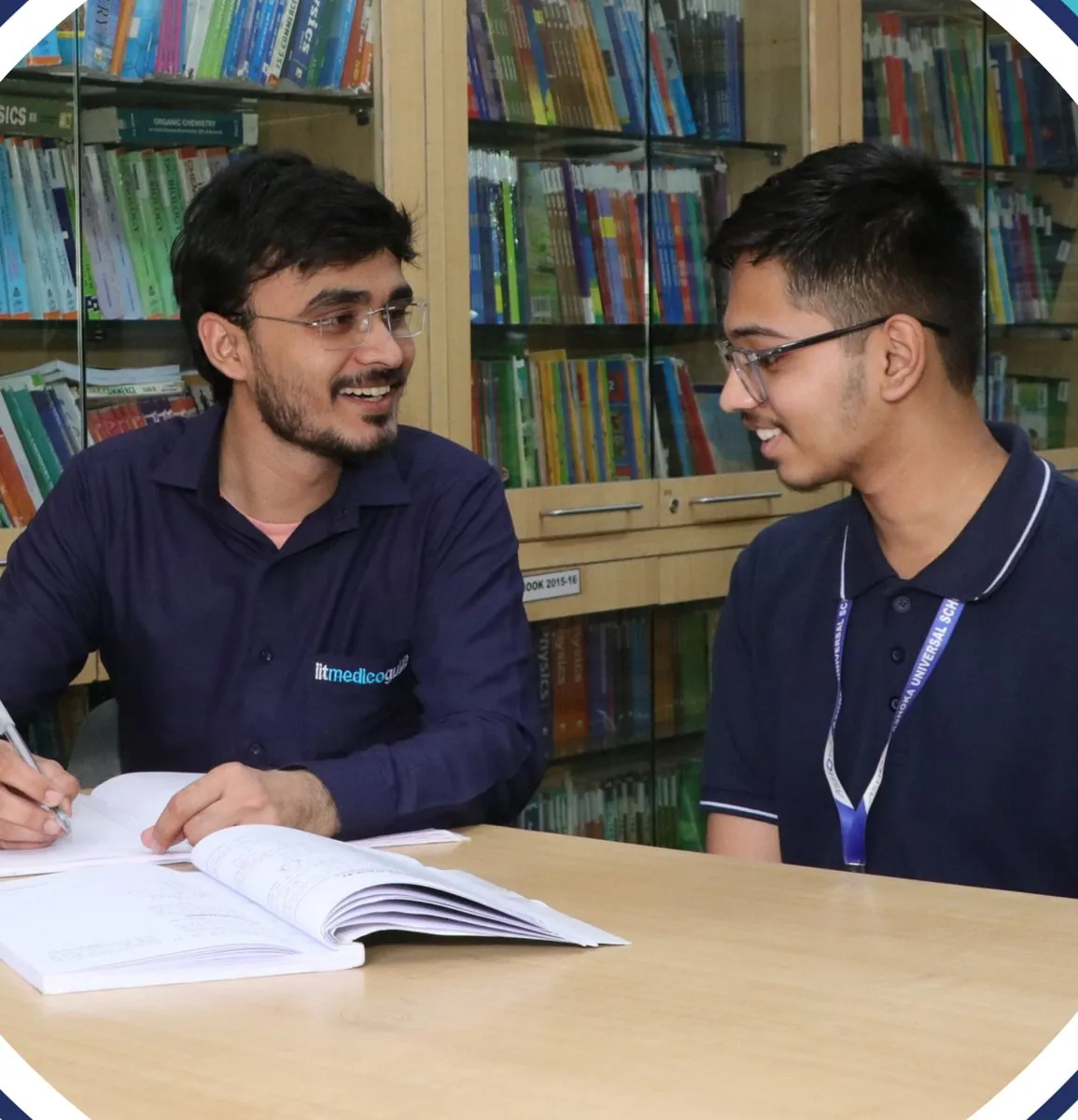A faculty member going through a student's work one to one in the library